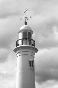 Low angle view of lighthouse against building