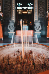 Close-up of lit candles in temple