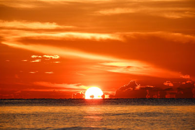 Scenic view of sea against romantic sky at sunset