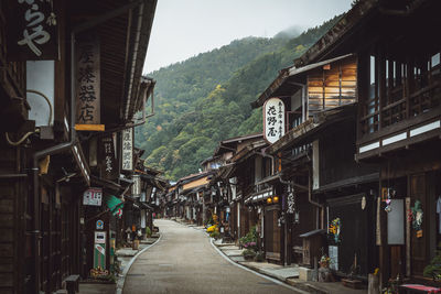 Street amidst houses and buildings in city