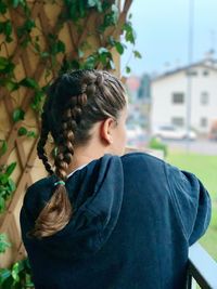 Rear view of woman standing outdoors