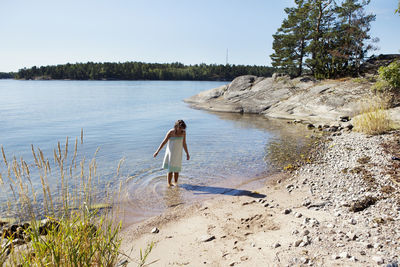 Woman wading in water, sweden