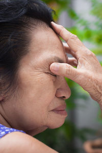 Side view of woman suffering from headache