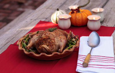 Close-up of roast chicken in container on table