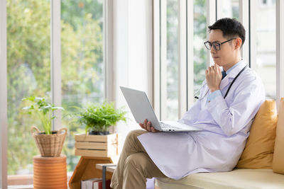 Mid adult man using mobile phone