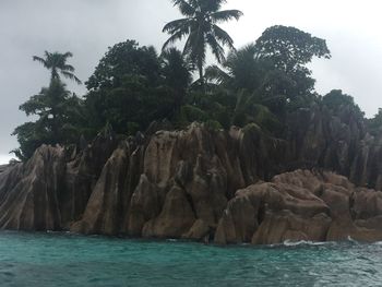 Scenic view of rocks in sea against sky