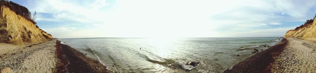 Scenic view of sea against cloudy sky