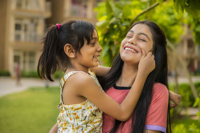 Cute girl touching sisters chick