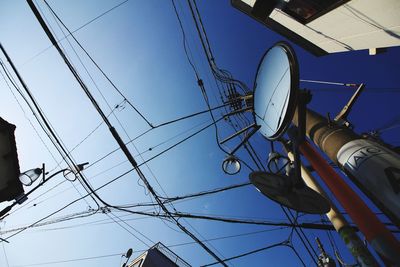 Low angle view of telephone pole against sky