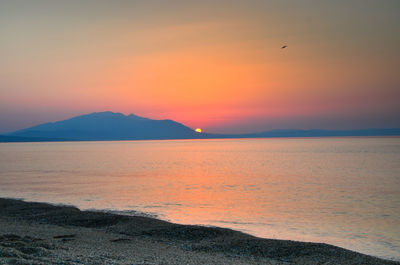 Scenic view of sea against orange sky