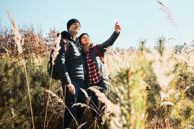 Couple exploring nature while vacation trip. hikers with backpacks. leisure time close to nature