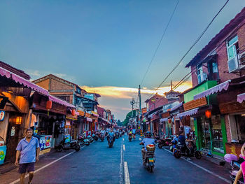 Street amidst buildings in city against sky