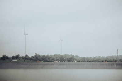 Scenic view of foggy weather against sky