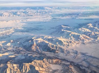 Aerial view of sea and mountains against sky