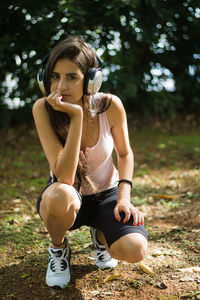 Portrait of young woman sitting in park