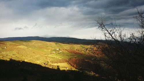 Scenic view of landscape against cloudy sky