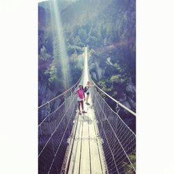 People walking on footbridge