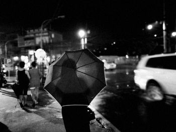 Close-up of hands on illuminated street
