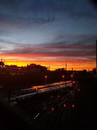 High angle view of railroad tracks against cloudy sky during sunset