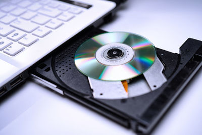 High angle view of compact disc in laptop cd player