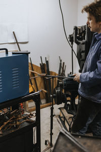 Male blacksmith working in workshop