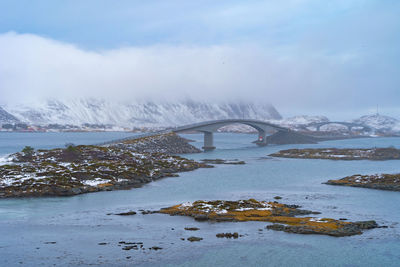 Bridge over sea against sky during winter