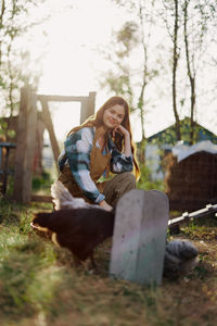 Portrait of young woman sitting on field