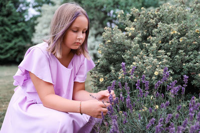 Young woman standing amidst plants