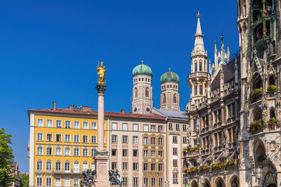 Low angle view of buildings against blue sky