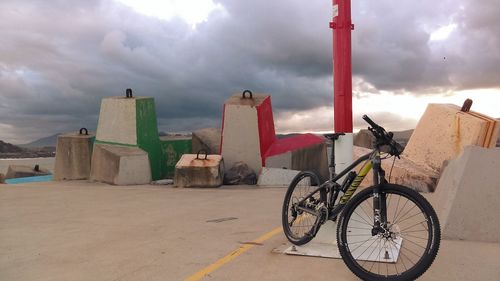 Bicycle by building against sky