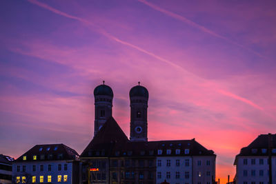 Buildings against sky at sunset