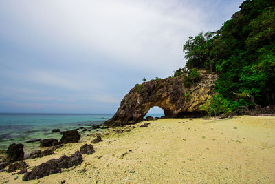 Rocks on beach against sky