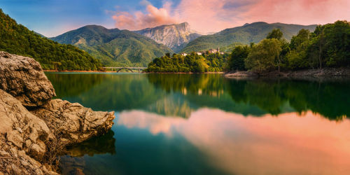 Scenic view of lake and mountains against sky