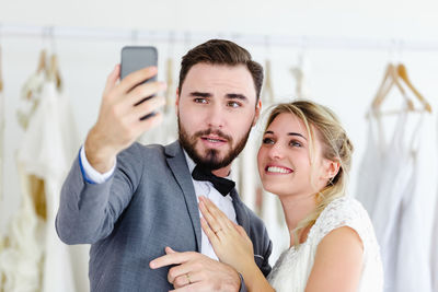 Portrait of smiling young woman using mobile phone