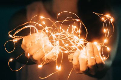 Close-up of illuminated light painting against black background