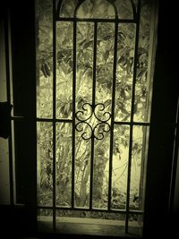 Close-up of metal grate through window