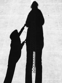 Shadow of man standing on wall