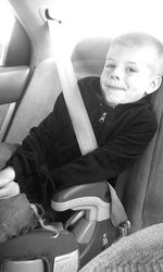 Portrait of smiling boy sitting on sofa