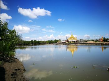 Historic temple by river against sky