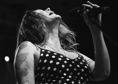 Low angle view of woman singing in concert