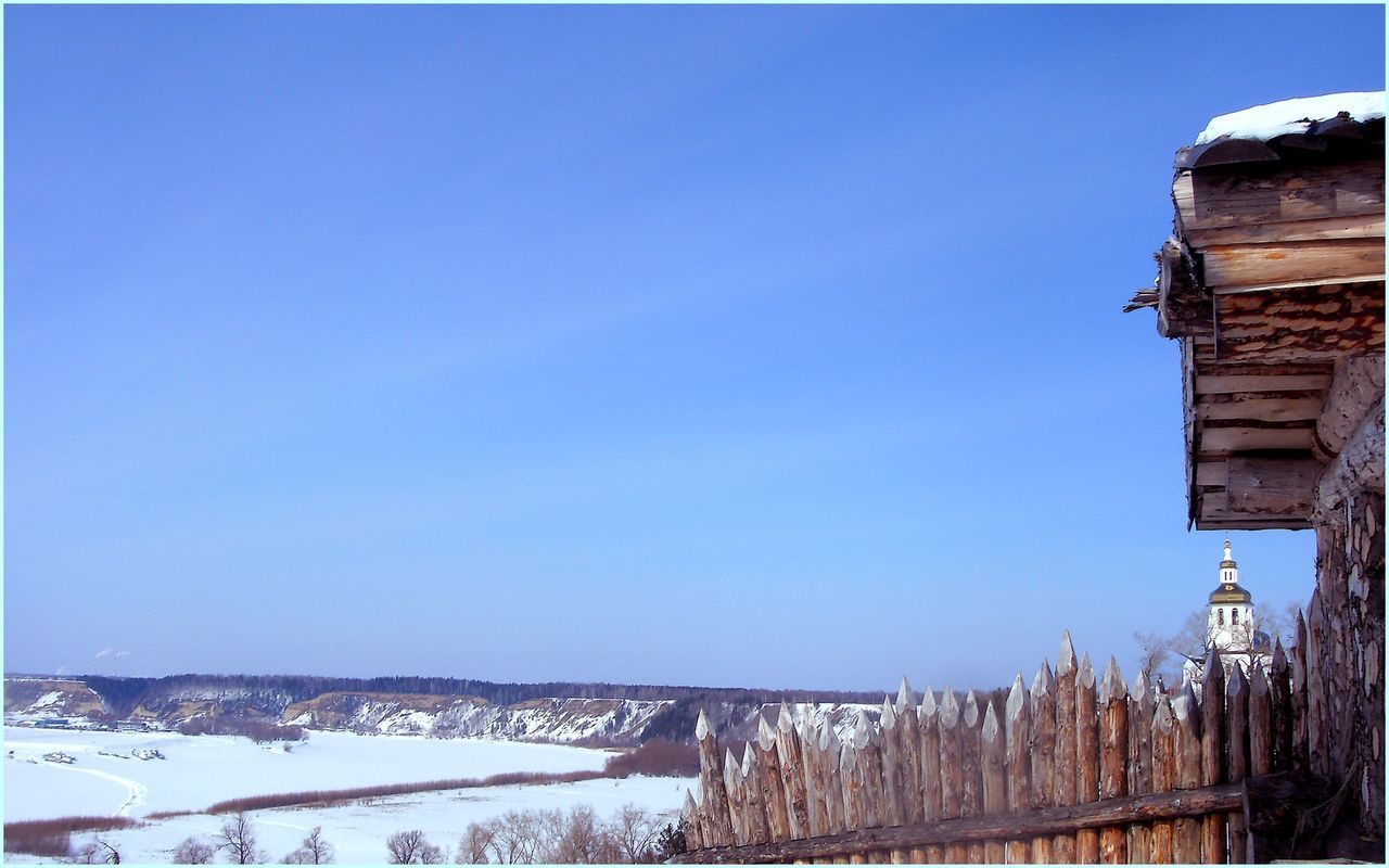 clear sky, copy space, blue, snow, winter, cold temperature, built structure, landscape, architecture, scenics, building exterior, tranquil scene, mountain, season, tranquility, nature, beauty in nature, house, day, outdoors