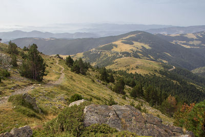 Scenic view of mountains against skyand path toward the valley