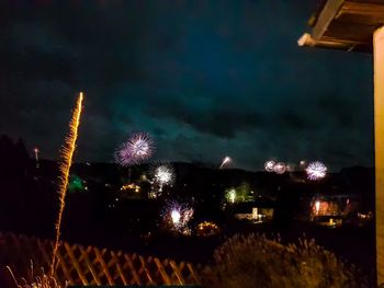 Low angle view of firework display at night