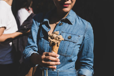 Midsection of man holding ice cream