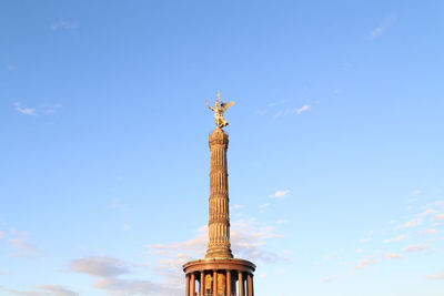 Low angle view of statue on column against sky