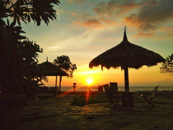 Scenic view of beach against sky during sunset