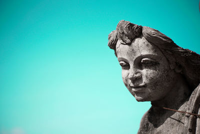 Close-up of statue against blue sky