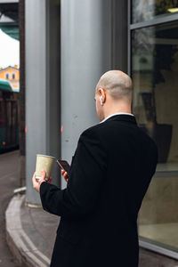 Side view of businessman using mobile phone