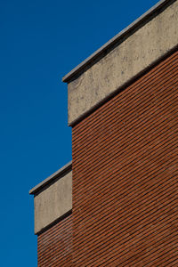 Low angle view of building against clear blue sky