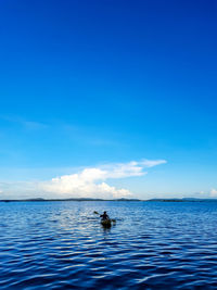 Scenic view of sea against blue sky